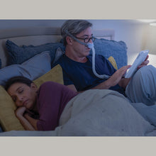 Load image into Gallery viewer, A man reading in bed using a cpap airfit n30 mask