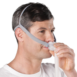 A man adjusting pillows on the cpap mask