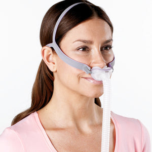 A woman using a airfit p10 nasal pillow cpap mask